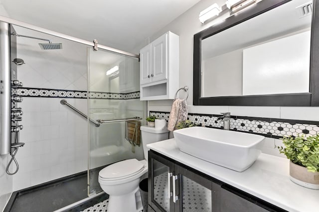 15451 Pembridge Dr Unit 207, Delray Beach, FL 33484 - bathroom featuring a shower stall, vanity, and backsplash