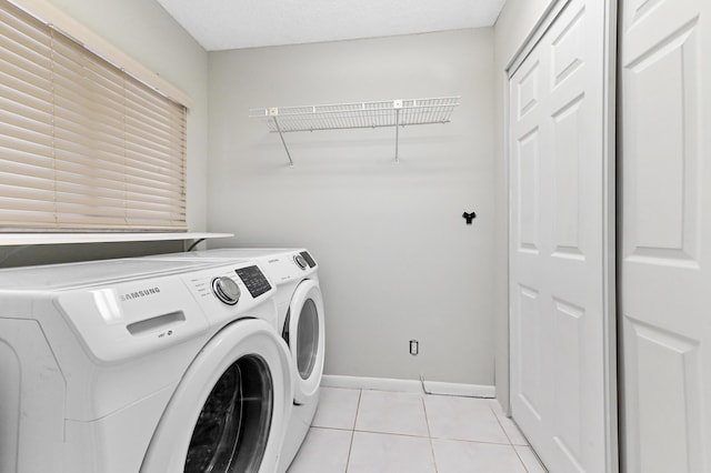 15451 Pembridge Dr Unit 207, Delray Beach, FL 33484 - laundry room featuring washer and dryer and light tile patterned floors