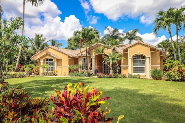 15687 83rd Way N, Palm Beach Gardens, FL 33418 - mediterranean / spanish house featuring stucco siding, a front yard, and a tile roof