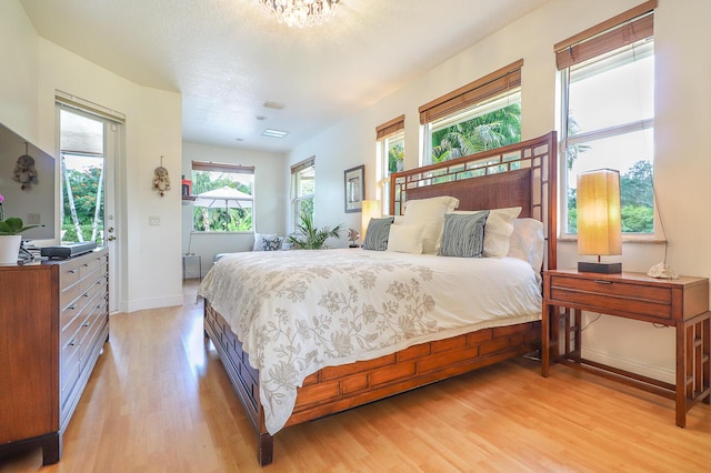 15687 83rd Way N, Palm Beach Gardens, FL 33418 - bedroom featuring light wood finished floors and baseboards