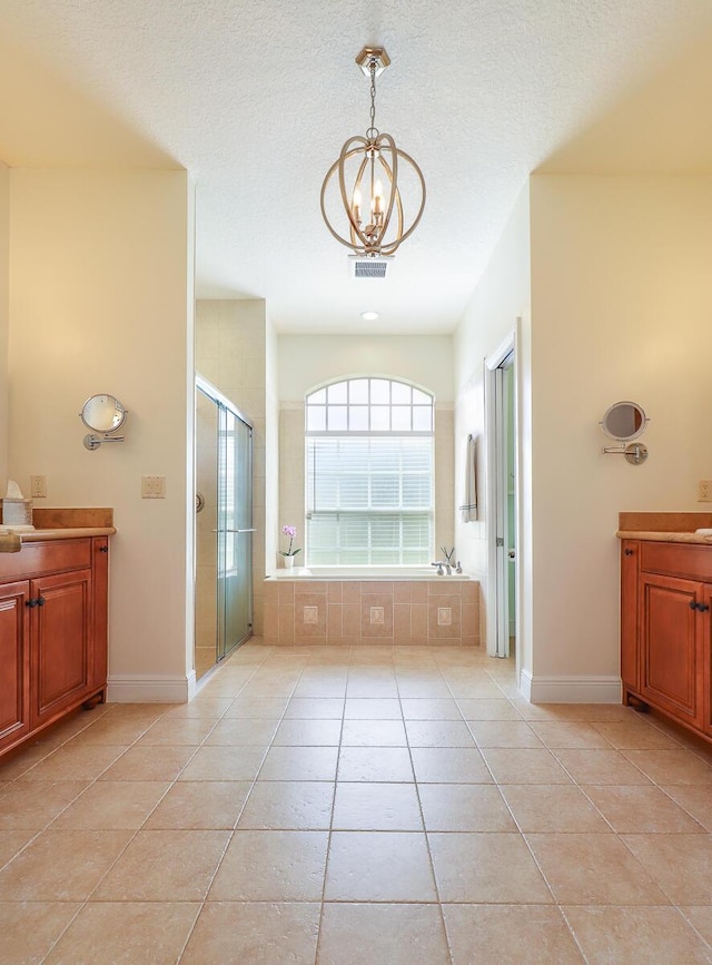 15687 83rd Way N, Palm Beach Gardens, FL 33418 - bathroom featuring vanity, tile patterned floors, a stall shower, a chandelier, and a garden tub