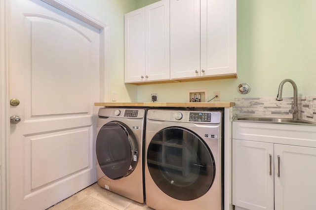 15687 83rd Way N, Palm Beach Gardens, FL 33418 - laundry room featuring independent washer and dryer, cabinet space, and light tile patterned flooring