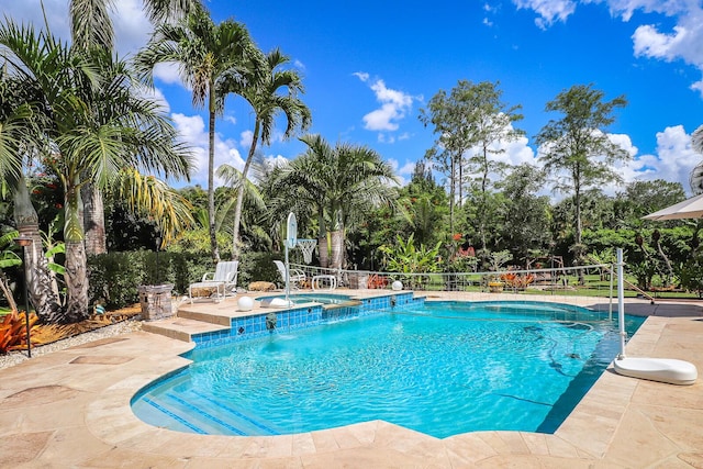 15687 83rd Way N, Palm Beach Gardens, FL 33418 - view of swimming pool featuring a patio area and a pool with connected hot tub