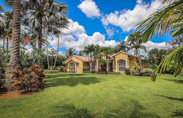 15687 83rd Way N, Palm Beach Gardens, FL 33418 - mediterranean / spanish home with stucco siding and a front lawn