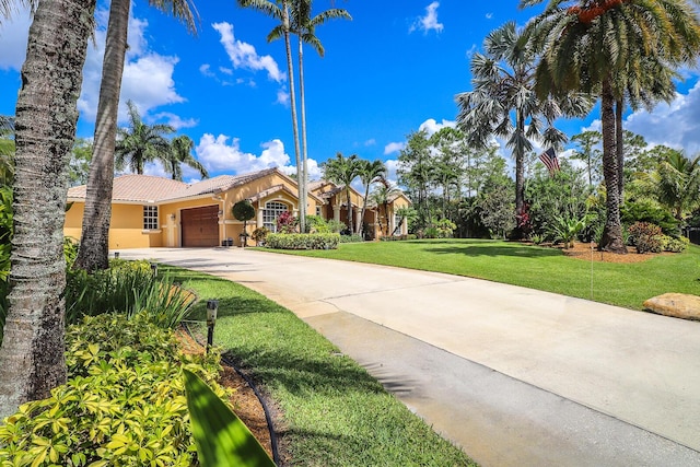 15687 83rd Way N, Palm Beach Gardens, FL 33418 - view of front facade featuring a garage, a tile roof, stucco siding, driveway, and a front yard