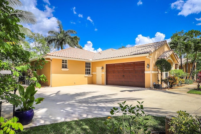 15687 83rd Way N, Palm Beach Gardens, FL 33418 - view of front facade with a tiled roof, stucco siding, driveway, and a garage