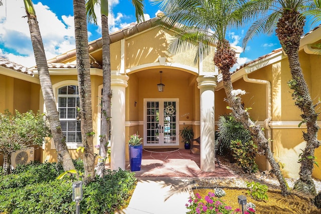 15687 83rd Way N, Palm Beach Gardens, FL 33418 - view of exterior entry with french doors and stucco siding