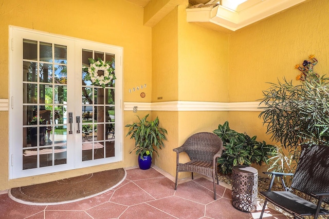 15687 83rd Way N, Palm Beach Gardens, FL 33418 - view of exterior entry with french doors, stucco siding, and a patio area