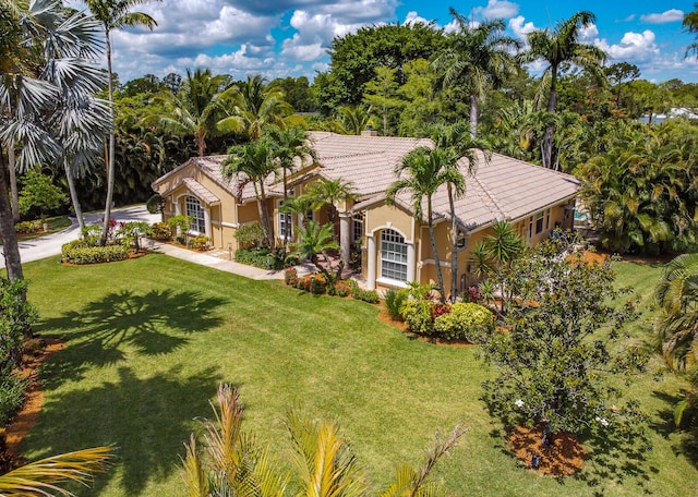 15687 83rd Way N, Palm Beach Gardens, FL 33418 - mediterranean / spanish-style home featuring stucco siding, a tiled roof, and a front lawn
