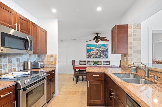 1501 SE 14th St, Deerfield Beach, FL 33441 - kitchen featuring appliances with stainless steel finishes, decorative backsplash, ceiling fan, light stone countertops, and recessed lighting