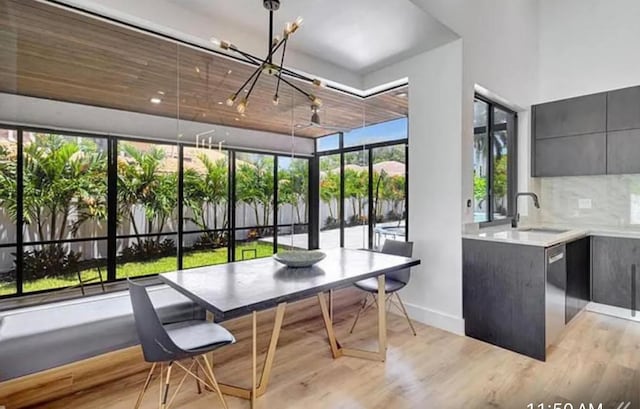 2299 NW 55th St, Boca Raton, FL 33496 - dining room with light wood finished floors and a chandelier