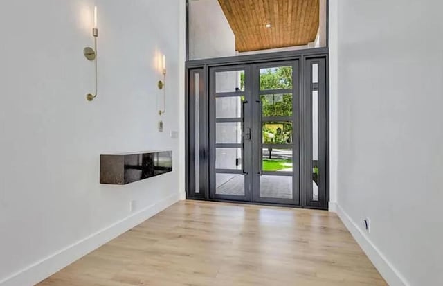 2299 NW 55th St, Boca Raton, FL 33496 - foyer entrance featuring wooden ceiling, french doors, wood finished floors, and a high ceiling