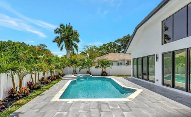 2299 NW 55th St, Boca Raton, FL 33496 - view of pool featuring a fenced backyard, a patio area, and a pool with connected hot tub