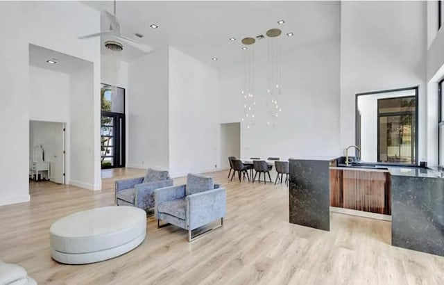 2299 NW 55th St, Boca Raton, FL 33496 - living room with a towering ceiling, light wood-style floors, ceiling fan, and recessed lighting