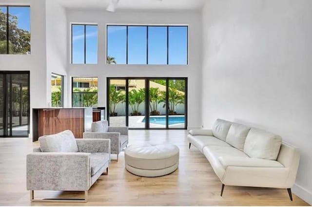 2299 NW 55th St, Boca Raton, FL 33496 - living room featuring healthy amount of natural light, wood finished floors, and a high ceiling