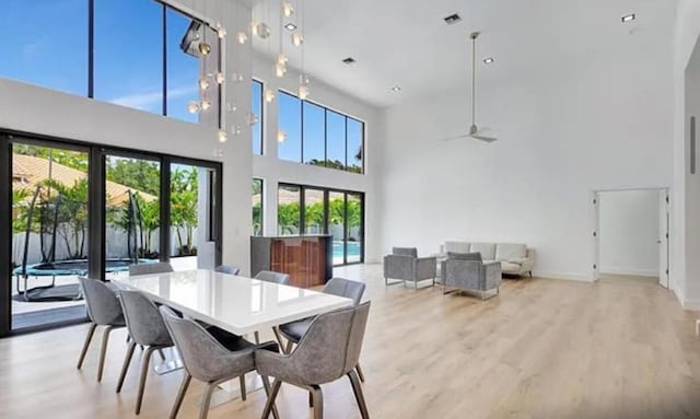 2299 NW 55th St, Boca Raton, FL 33496 - dining area featuring a high ceiling, light wood-style flooring, and ceiling fan