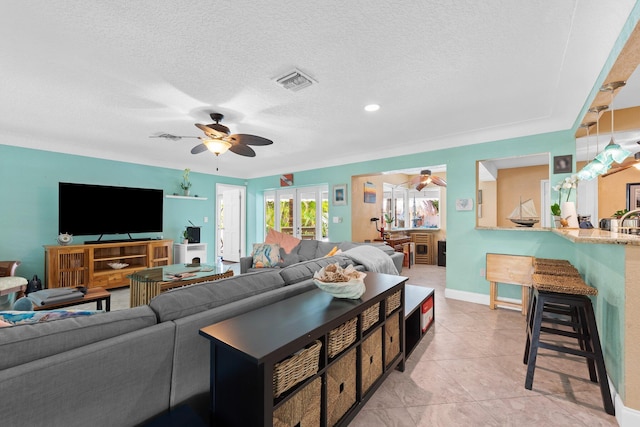 1098 SW 2nd St, Boca Raton, FL 33486 - living room featuring a ceiling fan, a textured ceiling, and light tile patterned floors