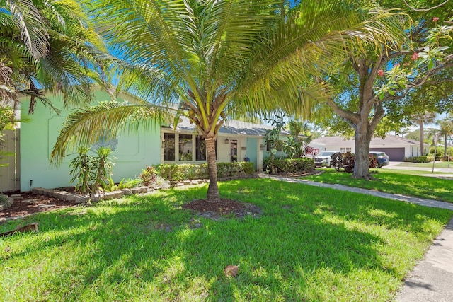 1098 SW 2nd St, Boca Raton, FL 33486 - view of front of house with a front lawn, stucco siding, and an attached garage