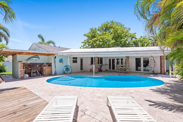 1098 SW 2nd St, Boca Raton, FL 33486 - outdoor pool featuring french doors, area for grilling, and a patio area