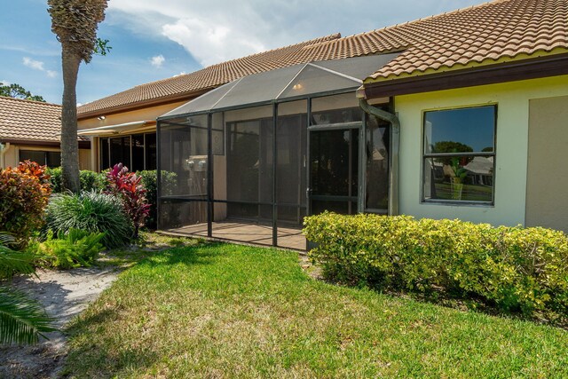 8057 Cassia Dr, Boynton Beach, FL 33472 - back of property featuring stucco siding, a tiled roof, and a yard
