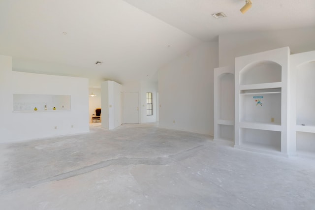 8057 Cassia Dr, Boynton Beach, FL 33472 - unfurnished living room with built in shelves, lofted ceiling, and unfinished concrete flooring