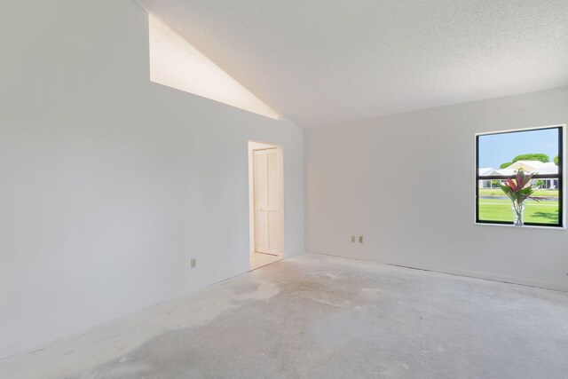 8057 Cassia Dr, Boynton Beach, FL 33472 - spare room featuring concrete flooring and vaulted ceiling