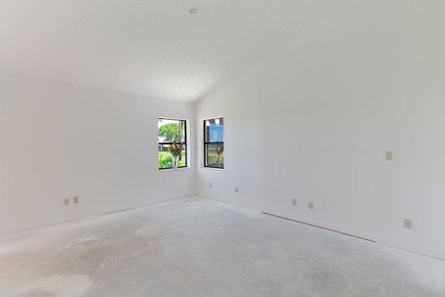 8057 Cassia Dr, Boynton Beach, FL 33472 - unfurnished room featuring unfinished concrete flooring and lofted ceiling