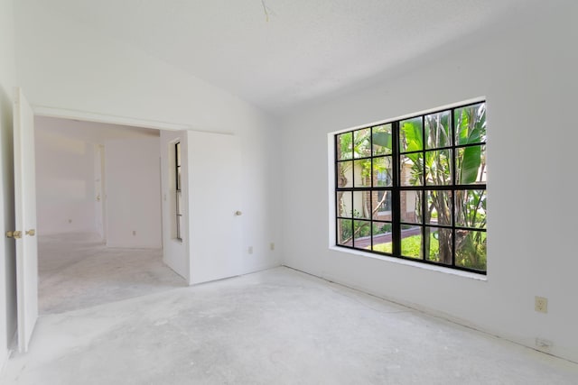 8057 Cassia Dr, Boynton Beach, FL 33472 - spare room featuring lofted ceiling and unfinished concrete floors