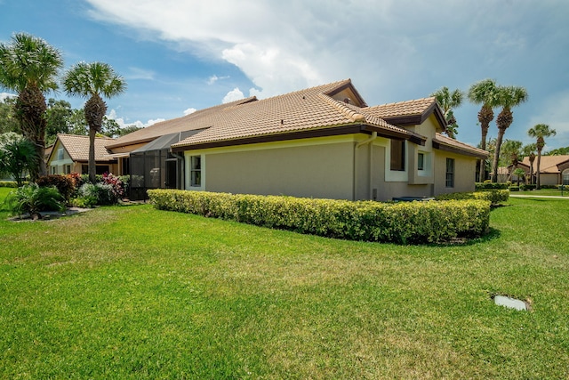 8057 Cassia Dr, Boynton Beach, FL 33472 - view of side of home featuring a tiled roof, a yard, and stucco siding