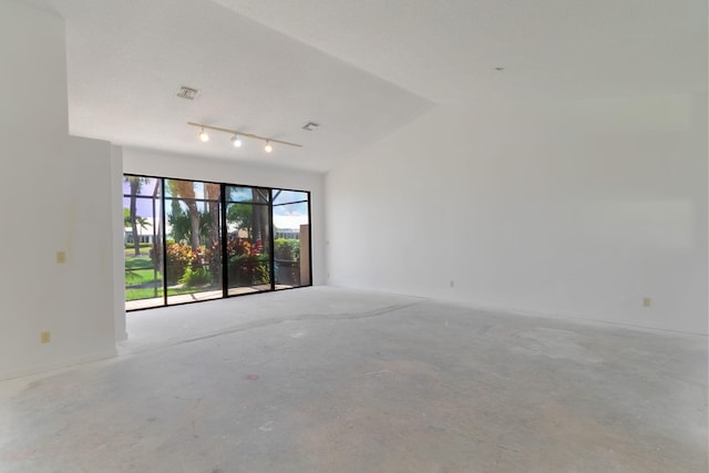 8057 Cassia Dr, Boynton Beach, FL 33472 - unfurnished room with concrete flooring, vaulted ceiling, and rail lighting