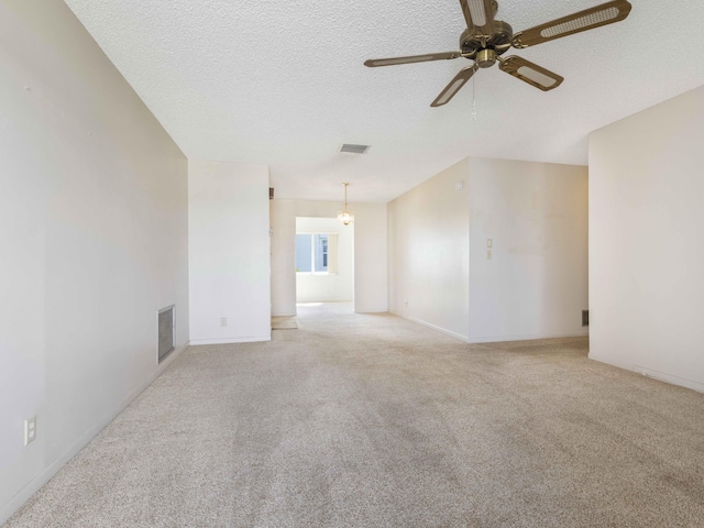 625 SW 21st Cir, Boynton Beach, FL 33426 - spare room featuring ceiling fan, carpet flooring, a textured ceiling, and a fireplace