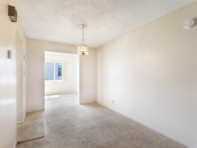 625 SW 21st Cir, Boynton Beach, FL 33426 - carpeted empty room with a chandelier, a smoke detector, and a textured ceiling