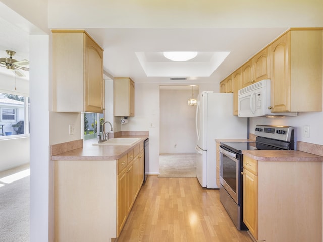 625 SW 21st Cir, Boynton Beach, FL 33426 - kitchen with stainless steel appliances, light brown cabinets, a raised ceiling, light countertops, and ceiling fan