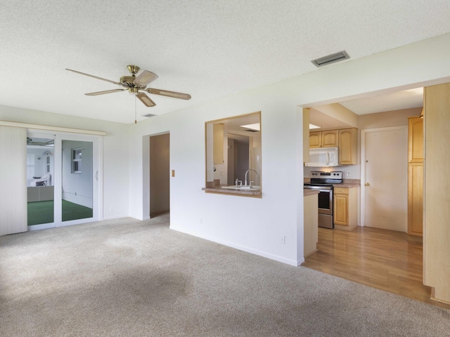 625 SW 21st Cir, Boynton Beach, FL 33426 - unfurnished living room with light carpet, ceiling fan, and a textured ceiling