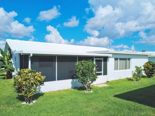 625 SW 21st Cir, Boynton Beach, FL 33426 - view of side of property featuring a sunroom, a yard, and stucco siding
