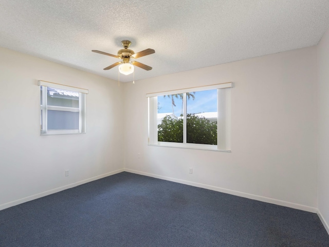 625 SW 21st Cir, Boynton Beach, FL 33426 - spare room featuring a textured ceiling, ceiling fan, and dark carpet