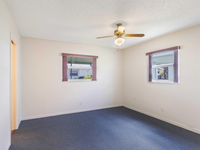 625 SW 21st Cir, Boynton Beach, FL 33426 - empty room with plenty of natural light, dark colored carpet, ceiling fan, and a textured ceiling
