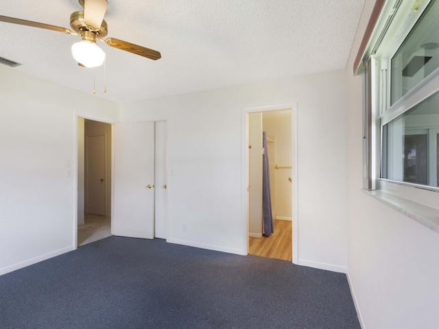 625 SW 21st Cir, Boynton Beach, FL 33426 - unfurnished bedroom with carpet floors, a textured ceiling, and a ceiling fan