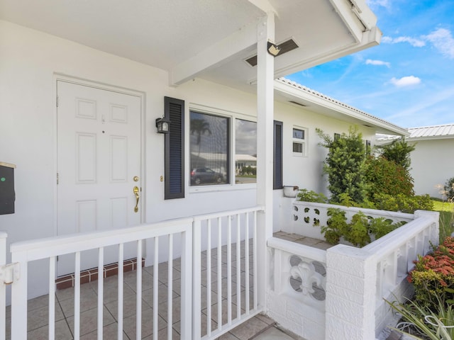 625 SW 21st Cir, Boynton Beach, FL 33426 - doorway to property with a porch and stucco siding