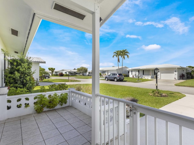 625 SW 21st Cir, Boynton Beach, FL 33426 - covered porch featuring a residential view, a yard, and concrete driveway
