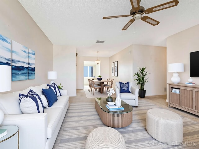 625 SW 21st Cir, Boynton Beach, FL 33426 - living area with light carpet, a ceiling fan, and a textured ceiling