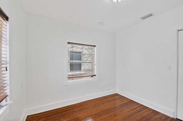 511 S K St, Lake Worth Beach, FL 33460 - empty room featuring dark wood-style flooring, healthy amount of natural light, and a smoke detector