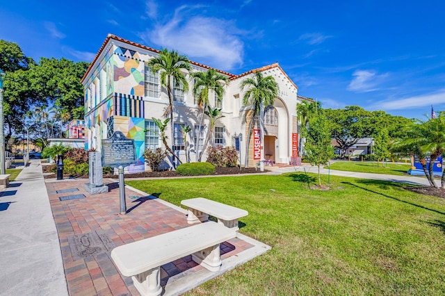 511 S K St, Lake Worth Beach, FL 33460 - mediterranean / spanish house with a front yard, stucco siding, and a tile roof
