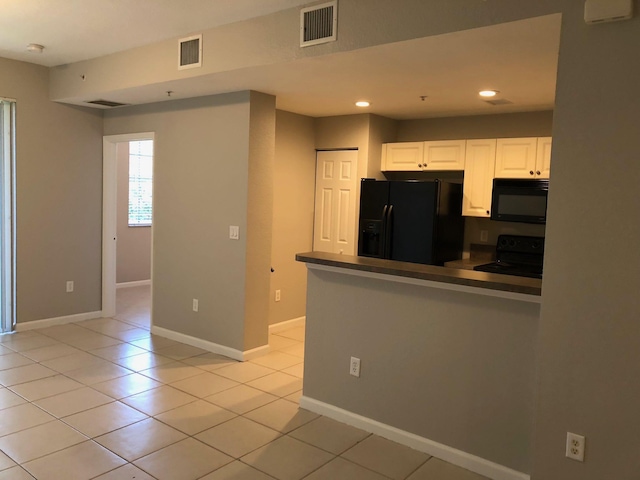 1991 Marsh Harbor Dr, Riviera Beach, FL 33404 - kitchen with black appliances, white cabinetry, a peninsula, recessed lighting, and dark countertops