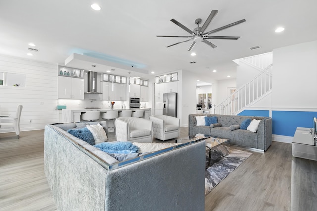 13313 Machiavelli Way, Palm Beach Gardens, FL 33418 - living room featuring light wood-style flooring, ceiling fan, recessed lighting, and stairs