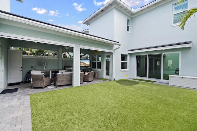 13313 Machiavelli Way, Palm Beach Gardens, FL 33418 - rear view of property with outdoor lounge area, stucco siding, a patio, and a lawn