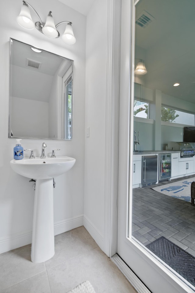 13313 Machiavelli Way, Palm Beach Gardens, FL 33418 - bathroom featuring beverage cooler, plenty of natural light, and tile patterned floors
