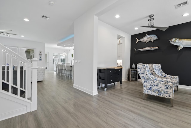 13313 Machiavelli Way, Palm Beach Gardens, FL 33418 - living area featuring wood finished floors, recessed lighting, stairway, and a ceiling fan
