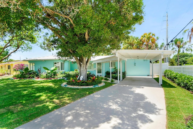 301 Linda Ln, West Palm Beach, FL 33405 - view of front facade with driveway, a carport, stucco siding, a standing seam roof, and a metal roof