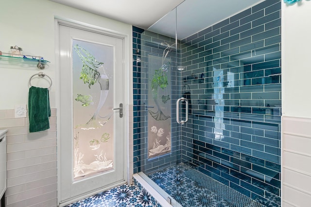 301 Linda Ln, West Palm Beach, FL 33405 - full bathroom with a stall shower, a wainscoted wall, and tile walls